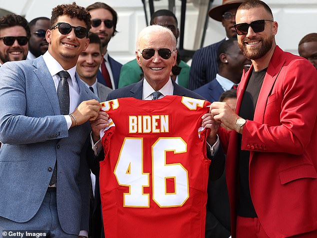 Joe Biden, pictured with the Kansas Chiefs stars in 2023, skipped the traditional pre-SuperBowl presidential interview last night, a 15-year White House tradition.