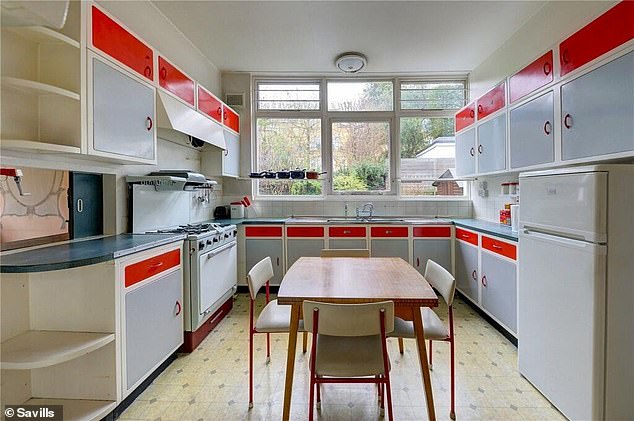 The property's kitchen features retro stacking chairs and red and gray Formica kitchen cabinets.