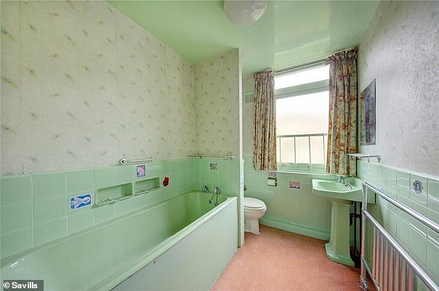 There are three bathrooms in the property, including this one with a light green bathroom.