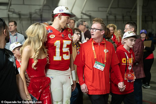 Chiefs quarterback Patrick Mahomes leaves the field after an all-time great performance alongside his wife Brittany.
