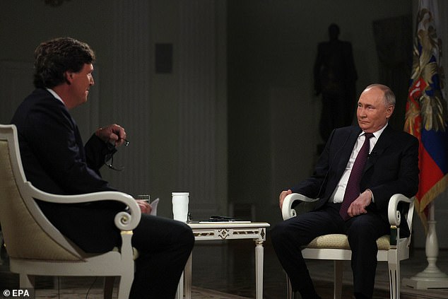 Russian President Vladimir Putin (R) attends an interview with American talk show host Tucker Carlson at the Moscow Kremlin on February 9, 2024.