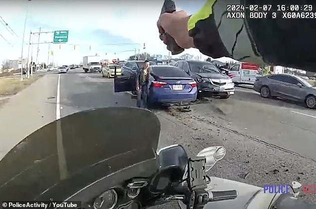 Another officer's body camera video tracks the vehicle on a police motorcycle. The video begins with the Toyota Camry now parked and Graham crouching next to it, visibly injured.