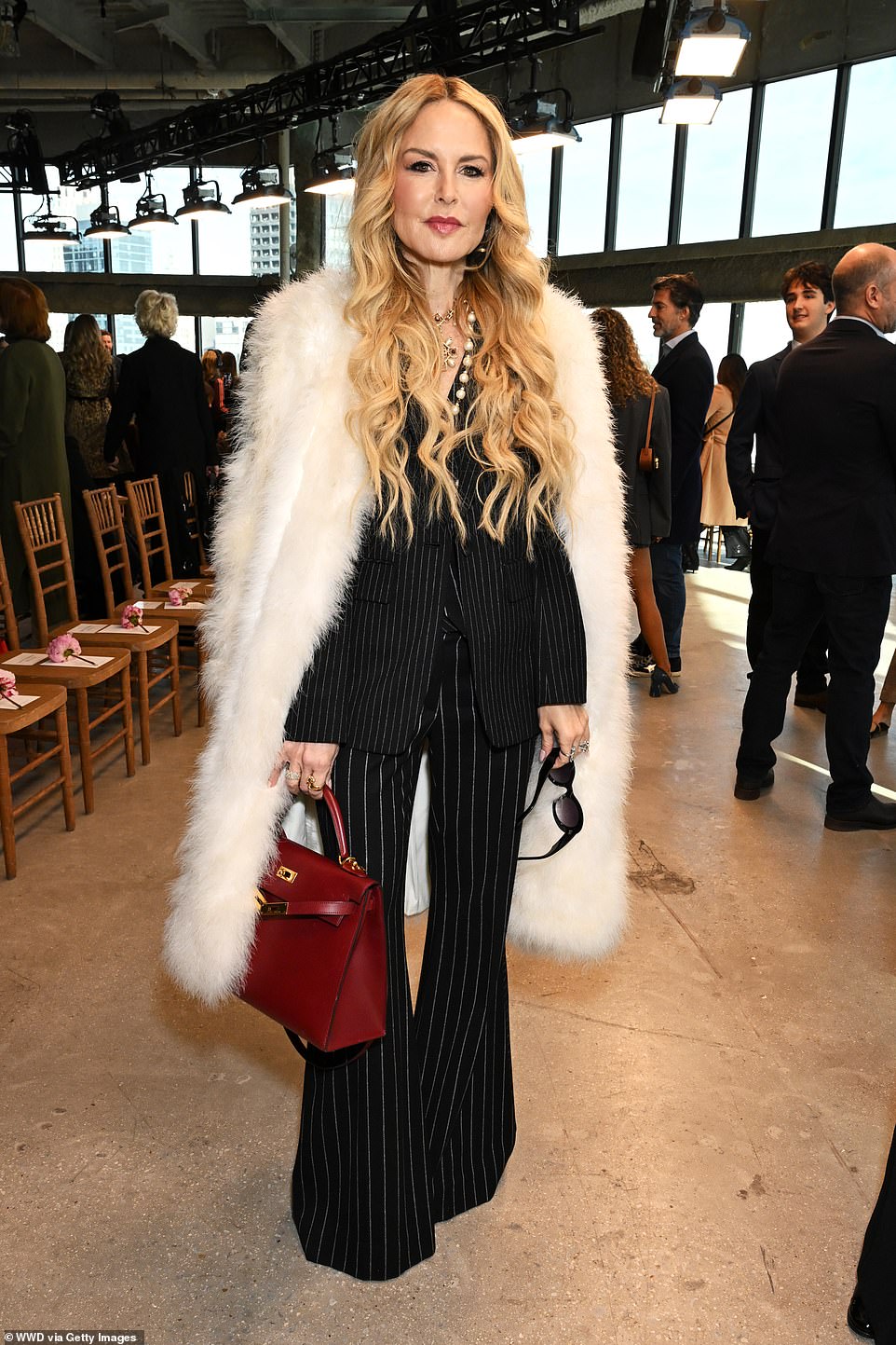 Rachel Zoe wore a striped-print look, which consisted of a jacket and flared pants, with a fur coat layered on top.