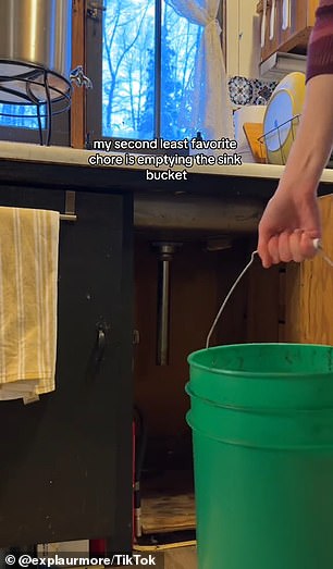 He has placed a jug with a faucet over the sink to wash dishes and keeps a large bucket underneath to catch the water after it goes down the drain.