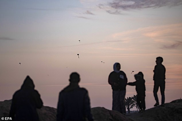 A Palestinian family on the beach at sunset near the Rafah refugee camp in the southern Gaza Strip