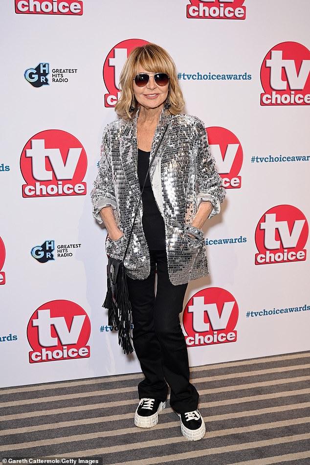 Lulu donned a jacket over a simple black ensemble as she strutted the red carpet in a pair of chunky sneakers.