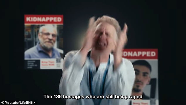 Rapaport becomes emotional when talking about the hostages held captive while posters of the hostages hang in the background.