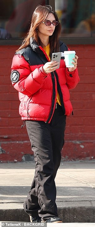 The 32-year-old model wore a yellow top under her cherry red The North Face quilted jacket with black trim.