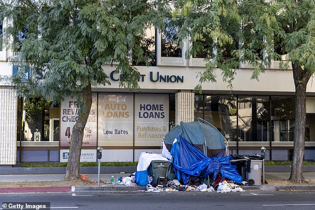 A homeless tent on the sidewalk in front of the Sacramento Credit Union office