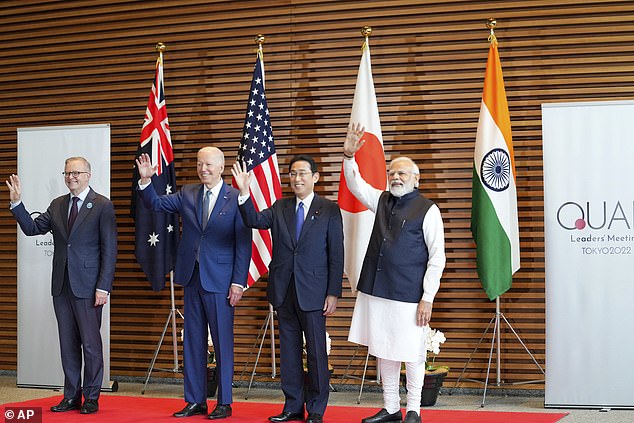 The four leaders waved to cameras as they posed for photos at the Tokyo summit.