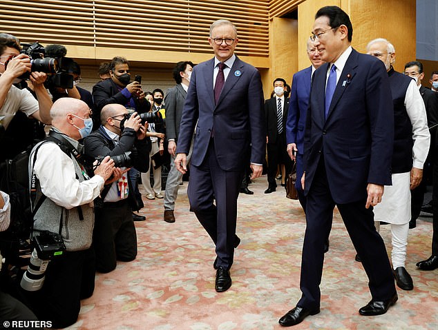 Prime Minister Fumio Kishida walks with Australia's new Prime Minister Anthony Albanese at the Quad summit