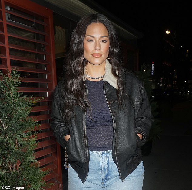 The model, 36, showed off her slender figure in a navy mesh top, acid wash capris jeans and a bomber jacket with a shearling collar.