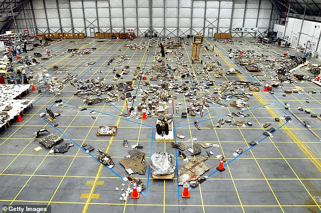 The remains of the space shuttle Columbia lie on the floor of the RLV hangar on May 15, 2003 at Kennedy Space Center, Florida