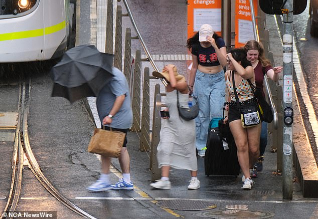 Melbourne commuters hit by heavy rain and winds