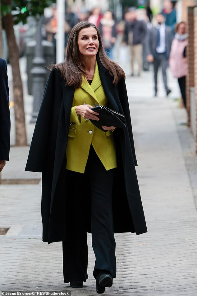 She paired her standout blazer with wide-leg pants and suede boots, and finished the look with a wool coat.