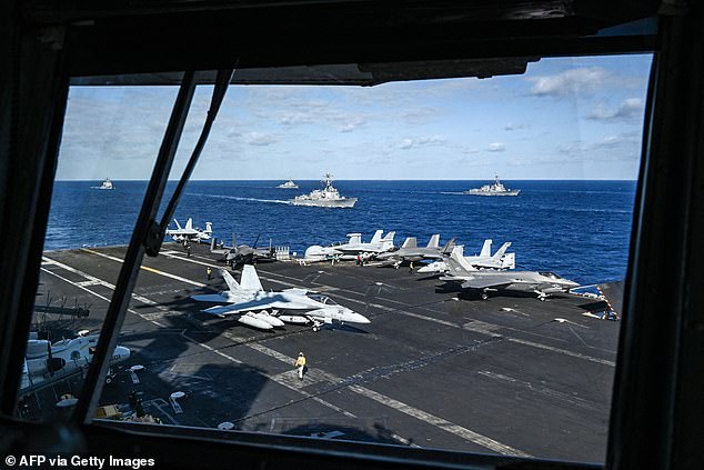 Fighter jets and ships are seen from the bridge of the aircraft carrier USS Carl Vinson during a three-day maritime exercise between the U.S. and Japan in the Philippine Sea Jan. 31, 2024.
