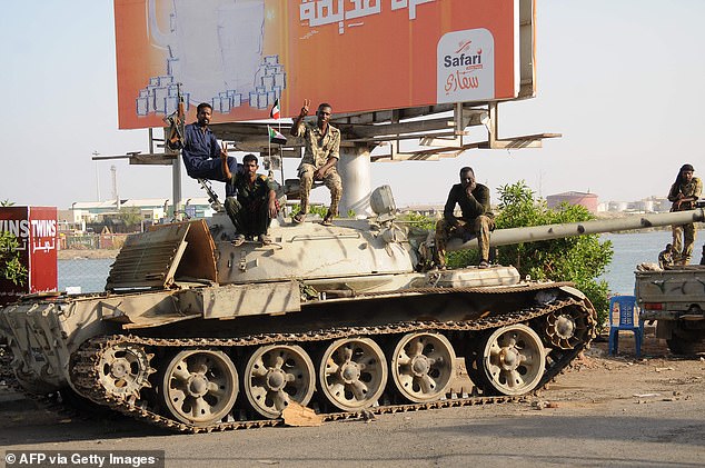 Sudanese army soldiers, loyal to army chief Abdel Fattah al-Burhan, sit atop a tank in the Red Sea city of Port Sudan.
