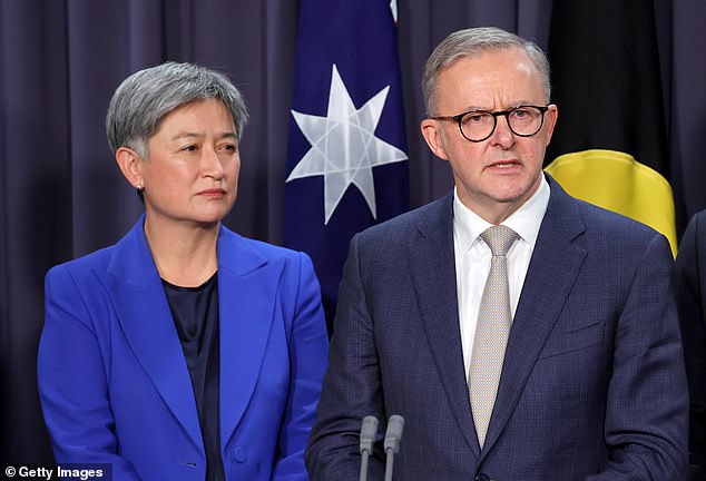 Joint effort: The Prime Minister is joined by Foreign Minister Penny Wong (left) and the head of the Office of National Intelligence and senior officials from the Department of Prime Minister and Cabinet and the Department of Foreign Affairs briefing on the trip . on