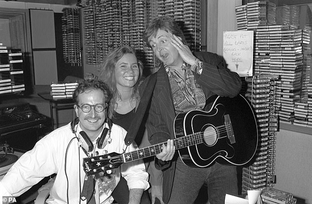 Wright being surprised in his studio by Paul McCartney.  Also in the photo is his production assistant Dianne Oxberry.