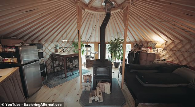 To heat the yurt, the couple uses a wood stove, but if they leave overnight they use an oil-filled radiator to keep their cats warm.