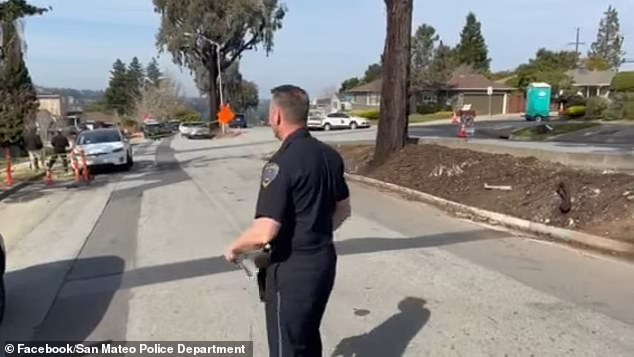 The couple was found with gunshot wounds along with a 9mm handgun and a loaded magazine in their bathroom on Monday morning, the San Mateo Police Department told DailyMail.com. (In the photo: an officer at the scene in the 4100 block of Alameda de las Pulgas)