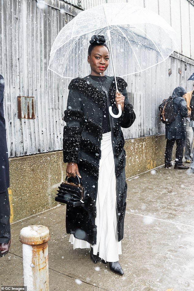 Black Panther actress Danai Gurira braved the elements for the show, wearing a long black fur coat and white skirt.
