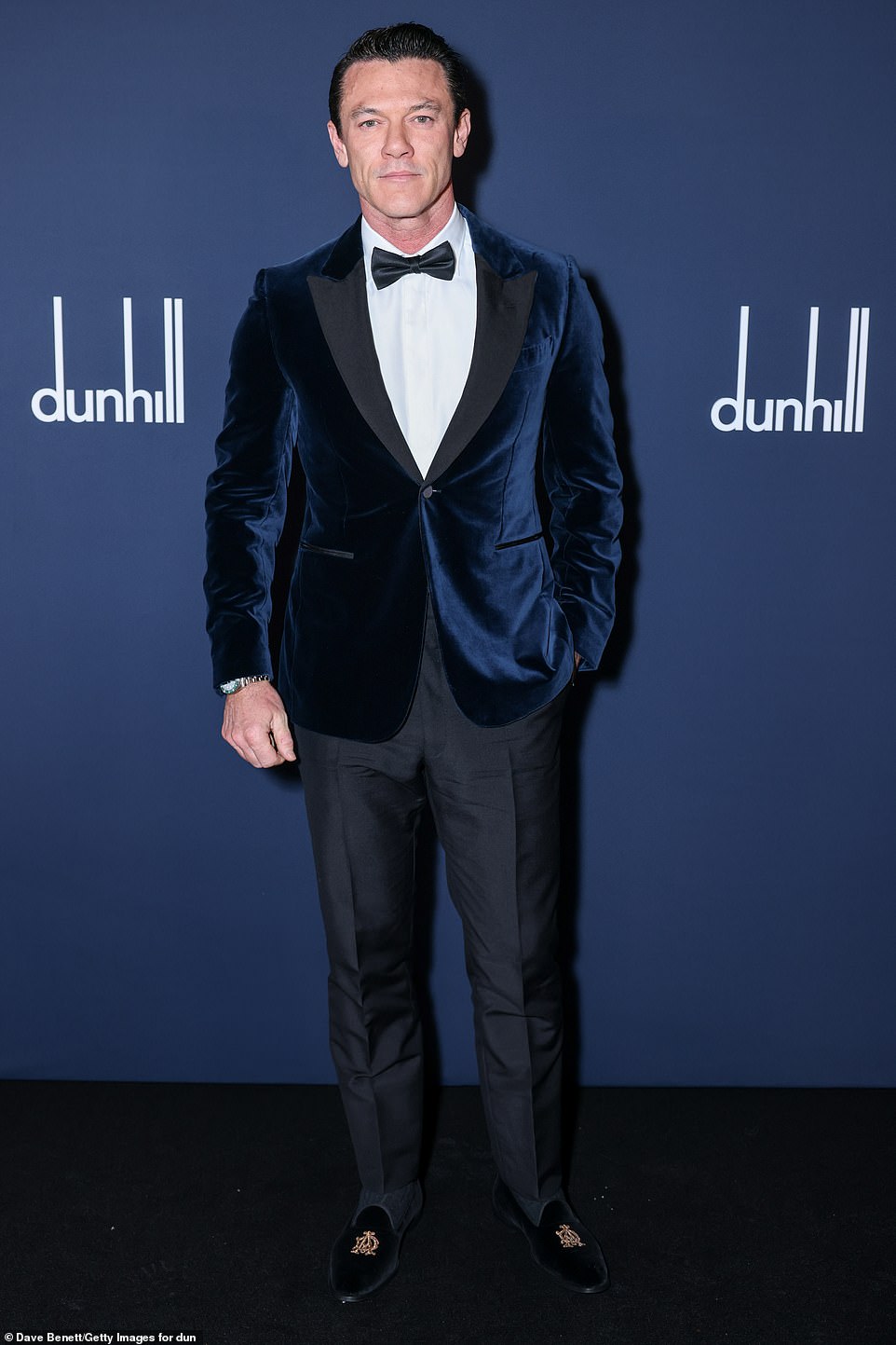 Luke Evans looked dapper in a navy velvet jacket which he paired with black trousers, a matching bow tie and a white shirt.