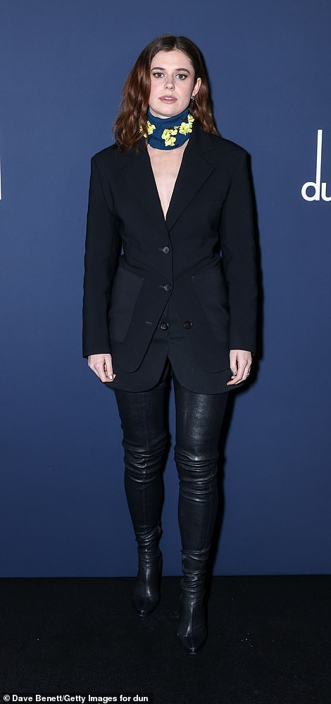 Alison Oliver looked incredible in a black blazer paired with a pair of matching leather boots.
