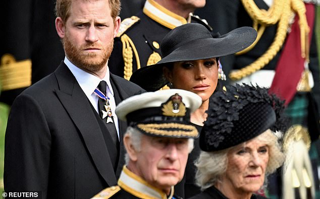 The Duchess of Sussex is seen crying alongside Prince Harry as the two stood behind King Charles and Queen Camilla at Queen Elizabeth's funeral.