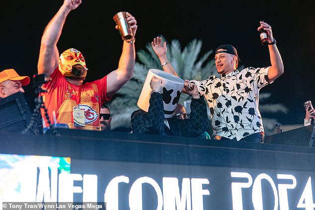 After the Chiefs, Jason (left) joined the party wearing a wrestling mask.