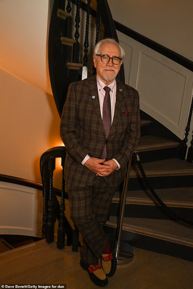The actor, 77, looked typically dapper in a smart beige plaid suit, with a pale pink collared shirt underneath.