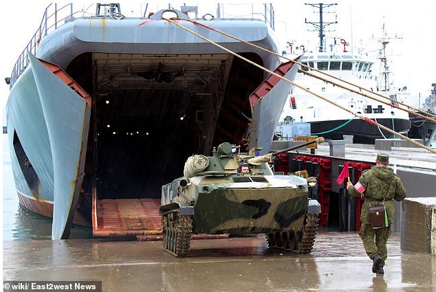 An armored vehicle disembarks from the landing ship Caesar Kunikov