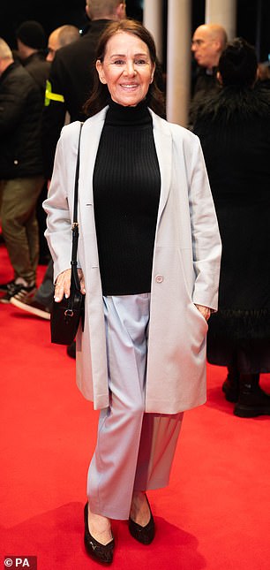Arlene Phillips, 80, cut a causal figure in a gray suit and black turtleneck as she arrived at the theater.