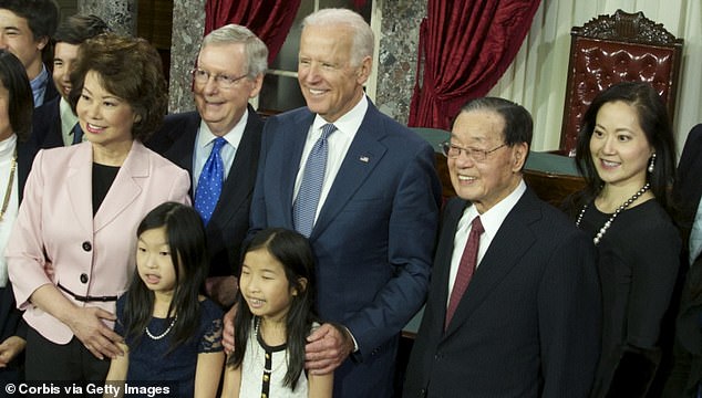 Angela Chao (far right) appears in 2015 with her sister, former Transportation Secretary Elaine Chao (left), her brother-in-law Mitch McConnell (second from left), now President Joe Biden (center), and her father. James Chao (second from right)