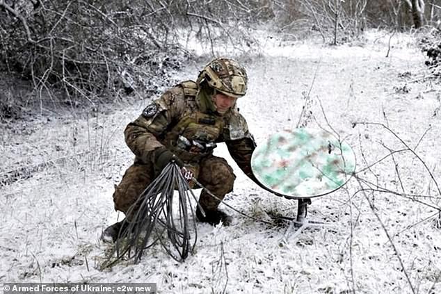 A Ukrainian soldier installing Starlink satellite equipment