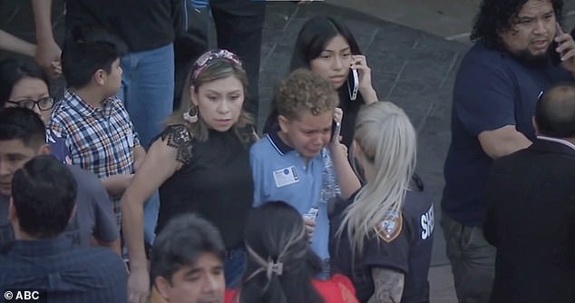Immediately after she began shooting, two off-duty police officers working as security at Lakewood Church shot and killed her.  Pictured: A boy crying on the phone leaving the church during the shooting.