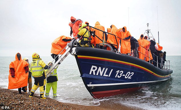 Parliament will quickly approve strict measures to deal with small boat arrivals, which could be in place by summer.  Pictured is a group being brought ashore at Dungeness yesterday.