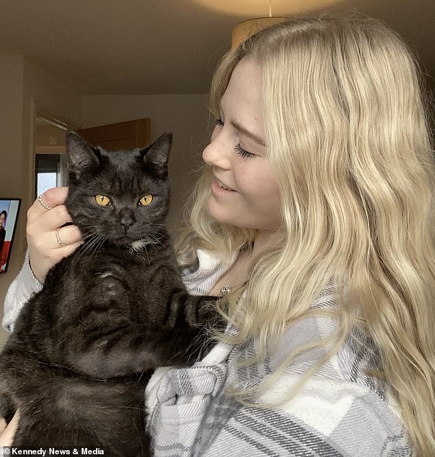 Pictured: Scott's client Emma Pickering with her cat Bertie, who was sitting at the bottom of the stairs when the plumber finally opened the door with Alfie.