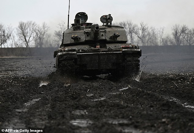 A Ukrainian serviceman from the 82nd Separate Air Assault Brigade prepares for combat in a Challenger 2 tank at an undisclosed location near the front line in the Zaporizhzhia region, February 12, 2024.