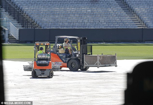 Construction workers could be seen at the MCG on Tuesday putting together hitmaker Trouble's iconic catwalk set.