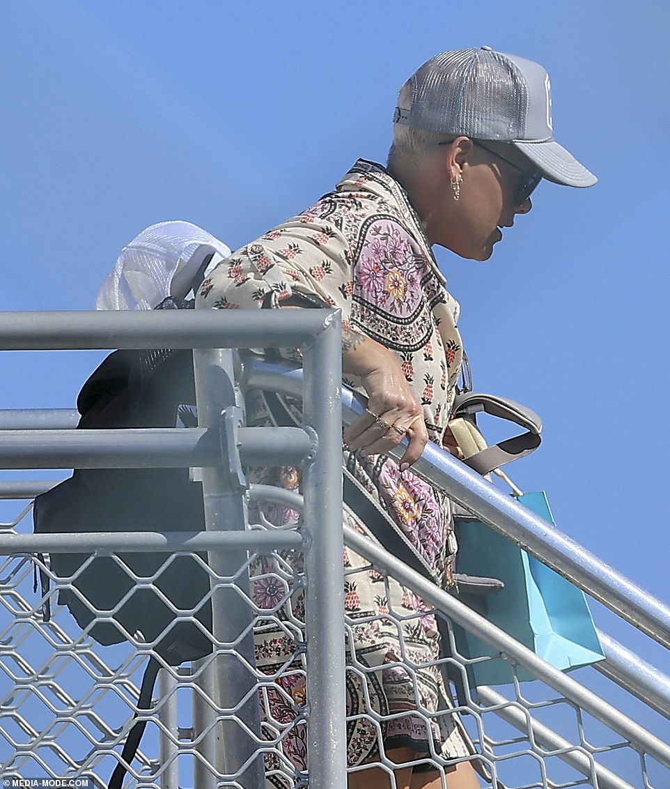 Pink looked dejected as she disembarked from the plane.