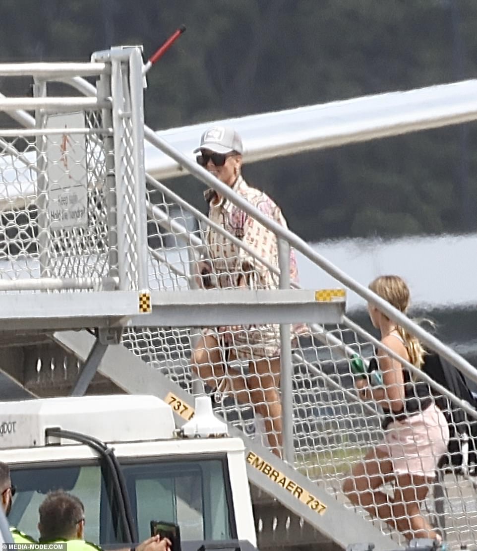 Pink flashed a smile as she boarded the plane in Sydney.