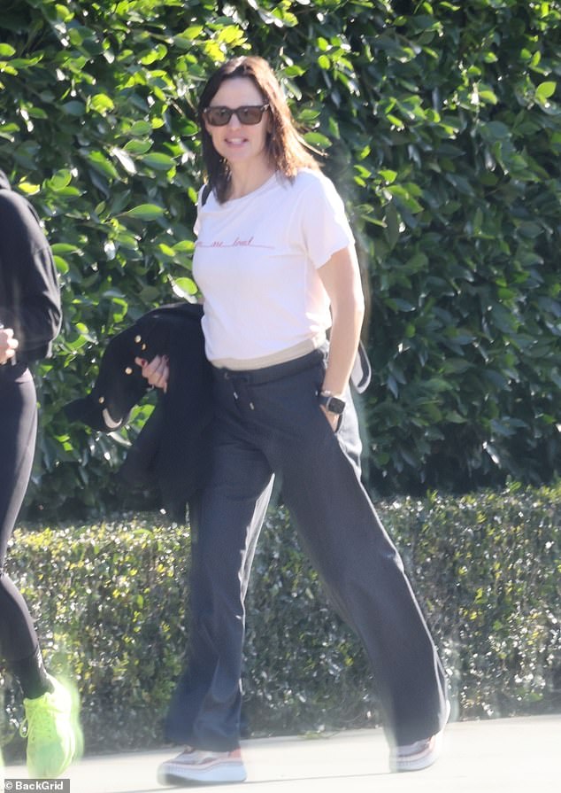He wore a black sweater with jeans and Nike sneakers, while Jennifer sported a casual white T-shirt, black sweatpants, and colorful platform sneakers.