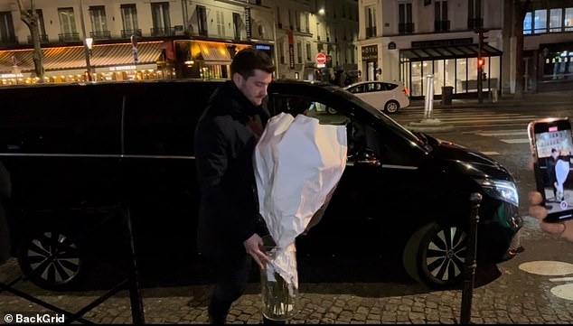 The couple's bodyguard was seen carrying the flowers that would be given to Rihanna during their romantic night in Paris.