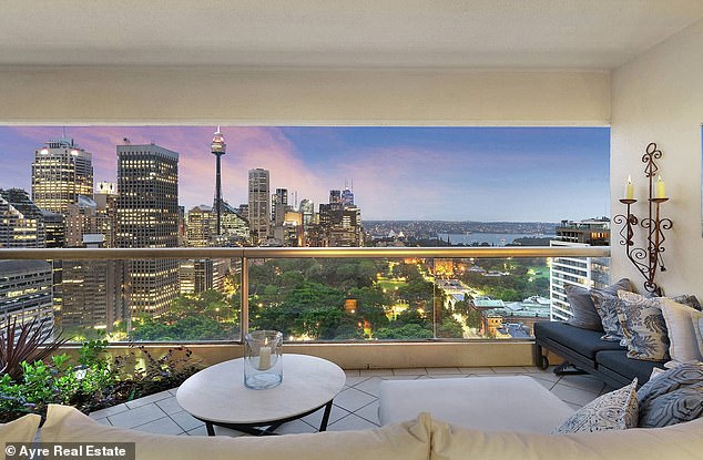 The apartment offers a panoramic view of the harbour, with the living room opening onto a spacious balcony facing north towards the Opera House.