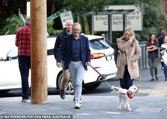 Mr Albanese, his pet Toto and his companion Jodie Haydon walking through Marrickville