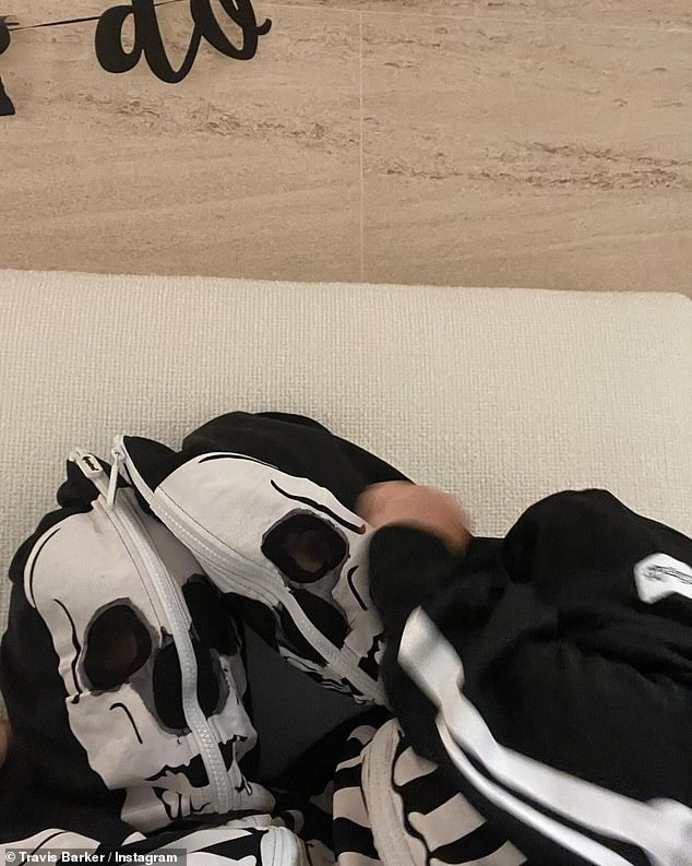 Lastly, she added a photo of them snuggling while wearing skeleton zip-up onesies.