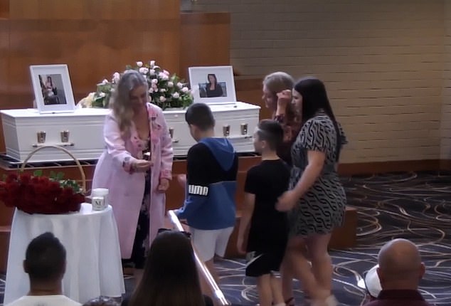 Bellamy's two children were escorted by their grandmother and aunt to the front of the chapel at the beginning of the ceremony to light candles.