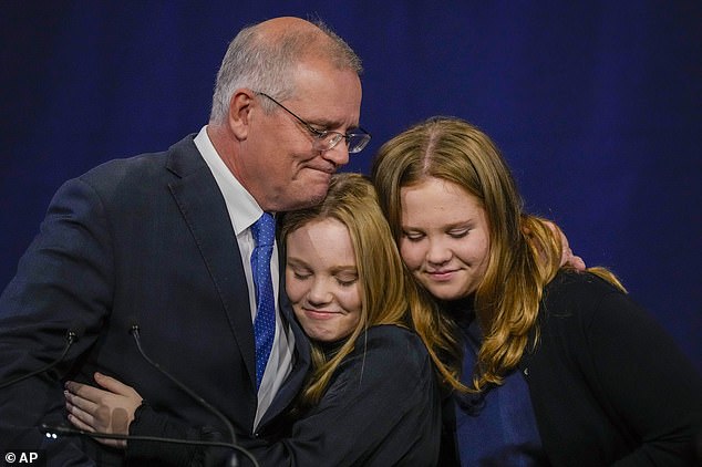 Outstanding: Morrison gave a concession speech to devastated Liberal supporters after calling Anthony Albanese to congratulate him on winning Labor for the first time since 2013. Pictured with his daughters Lily and Abbey.