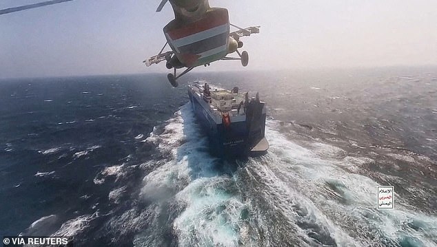 A Houthi military helicopter flies over the Galaxy Leader cargo ship in the Red Sea last month.